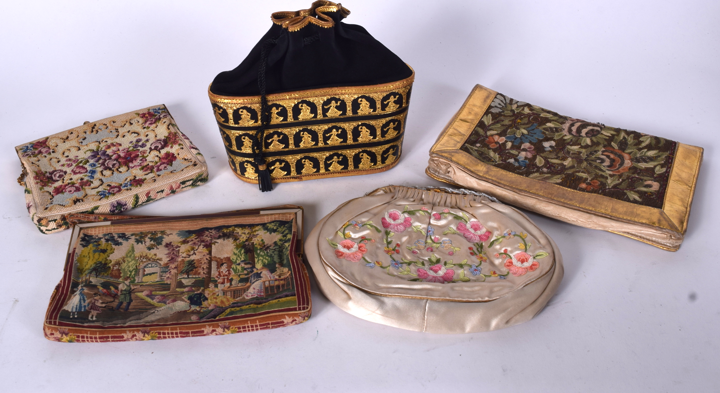 AN EARLY 20TH CENTURY FLORAL EMBROIDERED PURSE, together with four other examples of varying design