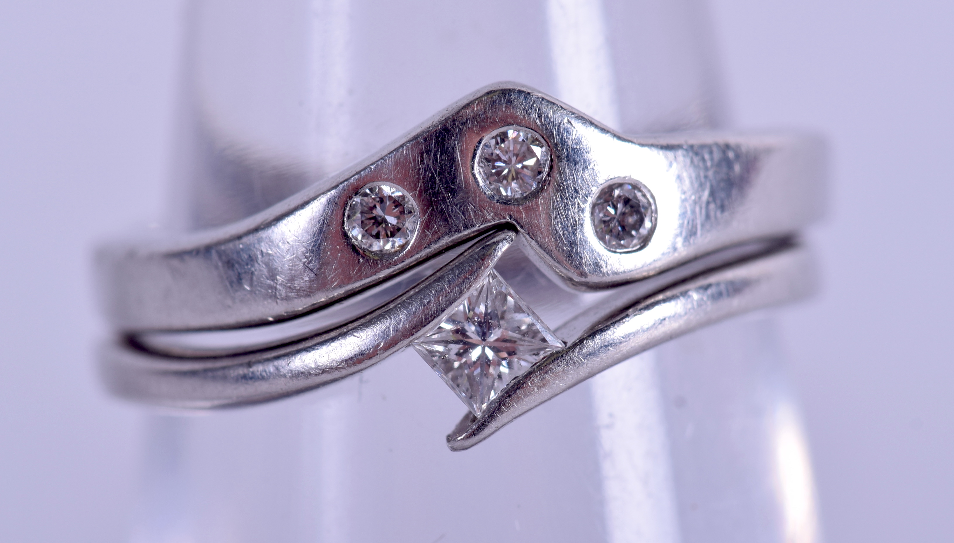 TWO PLATINUM AND DIAMOND WISHBONE RINGS. 6.6 grams. Size J/K. (2)