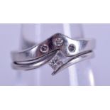 TWO PLATINUM AND DIAMOND WISHBONE RINGS. 6.6 grams. Size J/K. (2)