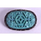 A 19TH CENTURY CHINESE CARVED TURQUOISE BROOCH Qing, mounted in silver. 4.5 cm x 3.5 cm.