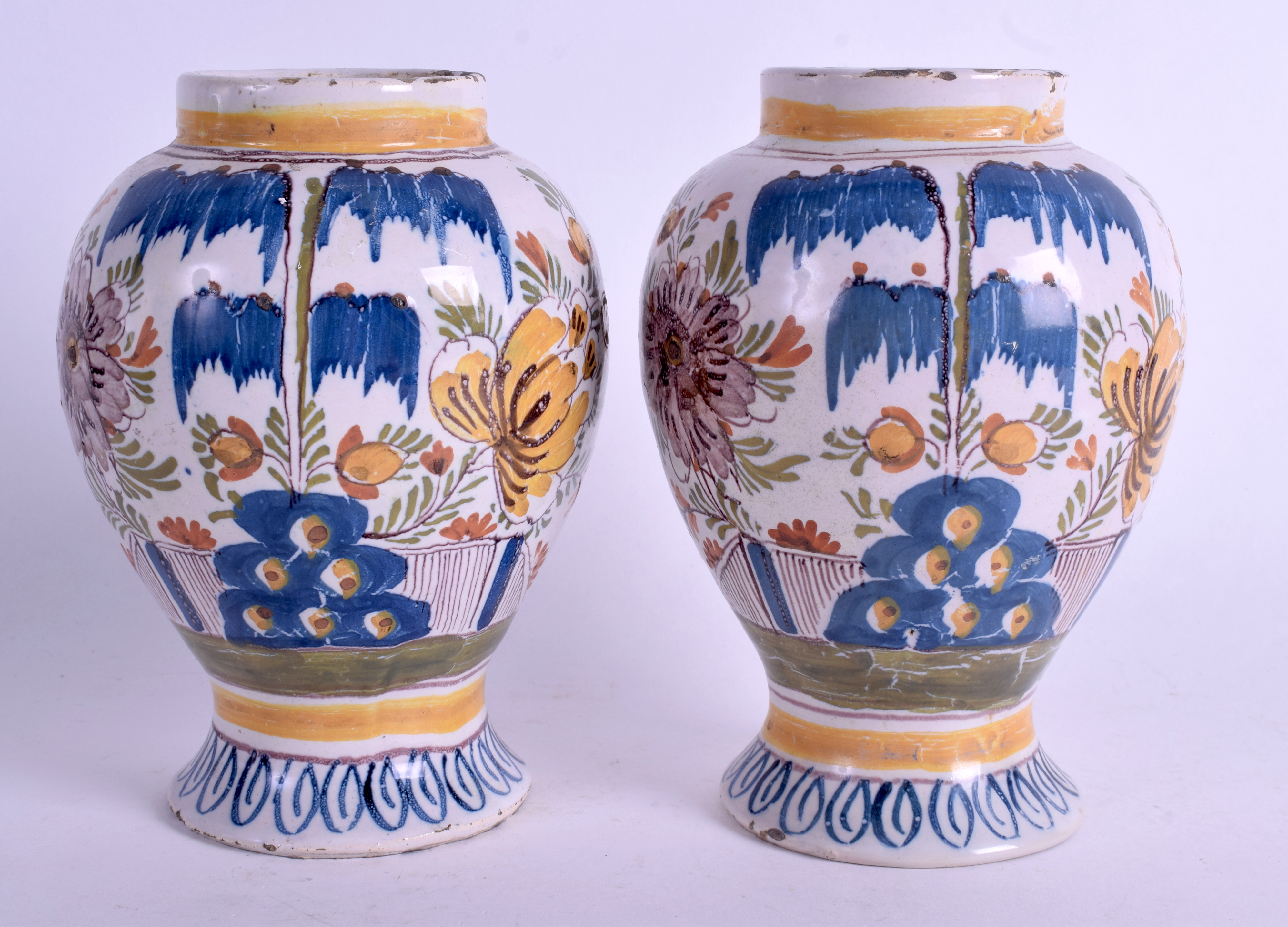 A PAIR OF 18TH CENTURY DUTCH DELFT POLYCHROME VASES painted with floral sprays. 16 cm high.