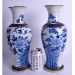 A LARGE PAIR OF 19TH CENTURY CHINESE BLUE AND WHITE VASES painted with birds and foliage. 35 cm hig