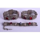 A PAIR OF MIDDLE EASTERN SILVER AND AGATE BRACELETS together with another. 8.2 oz. (3)