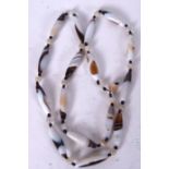 AN AGATE NECKLACE, formed with torpedo shaped beads. 66 cm long.