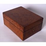 AN ANTIQUE WALNUT TOILET BOX, formed with brass escutcheon. 21 cm long.