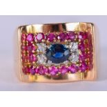 A 1970S 18CT GOLD RUBY DIAMOND AND SAPPHIRE RING. 10.7 grams. Size S/T.