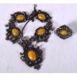 AN ANTIQUE SILVER NECKLACE INSET WITH YELLOW STONE DECORATION, together with a matching brooch. Nec