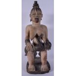 A RARE LARGE VINTAGE POLYCHROMED WOOD TRIBAL FERTILITY FIGURE modelled with a suckling child. 57 cm