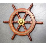 AN ANTIQUE SHIPS WHEEL, formed with brass banding. 56 cm wide.
