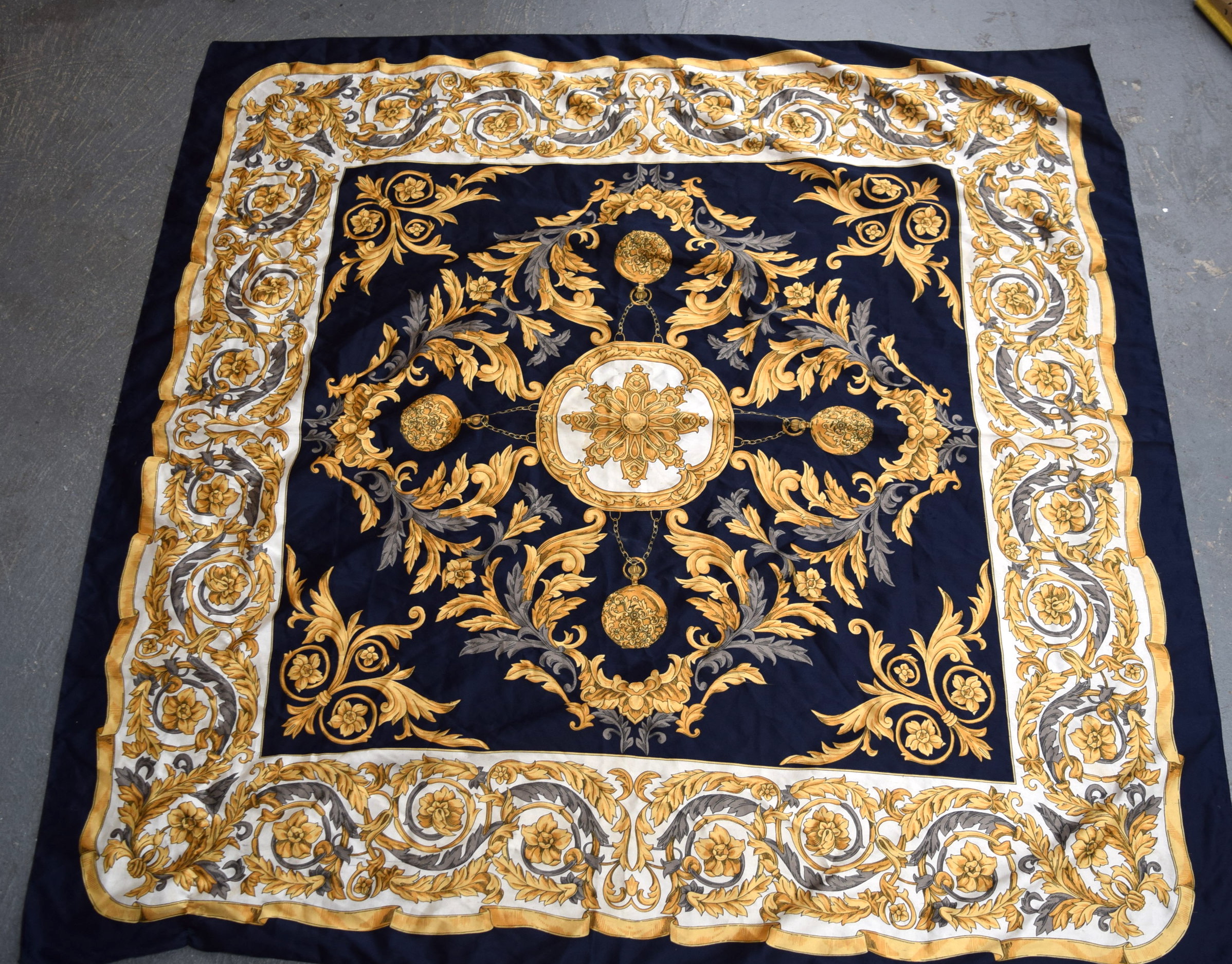 A VINTAGE VERSACE SILK SCARF OR SHAWL, decorated with foliage and hanging pocket watches. 112 cm x 1