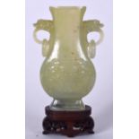 AN EARLY 20TH CENTURY CHINESE GREEN JADE VASE, formed with mythical beast head handles and carved w