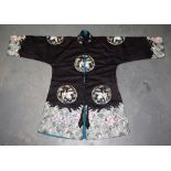 AN EARLY 20TH CENTURY CHINESE MIDNIGHT BLACK SILKWORK JACKET decorated with birds and foliage. 86 c