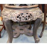 A LARGE 19TH CENTURY JAPANESE MEIJI PERIOD WOODEN STAND, carved with mask heads. 60 cm x 66 cm.