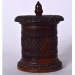 AN ANTIQUE WOODEN TEA CADDY, formed with acorn finial and carved with foliage. 14 cm high.