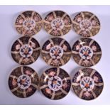 A SET OF NINE EARLY 19TH CENTURY ENGLISH PORCELAIN PLATES painted with flowers and gilt. 20 cm diam