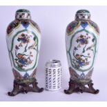 A GOOD PAIR OF 19TH CENTURY FAMILLE VERTE BALUSTER VASES AND COVERS Kangxi Style, painted with bird