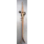 A PAIR OF ANTIQUE WOODEN SKIS, with metal spring mounts, bearing serial “stamp”. 206 cm long.