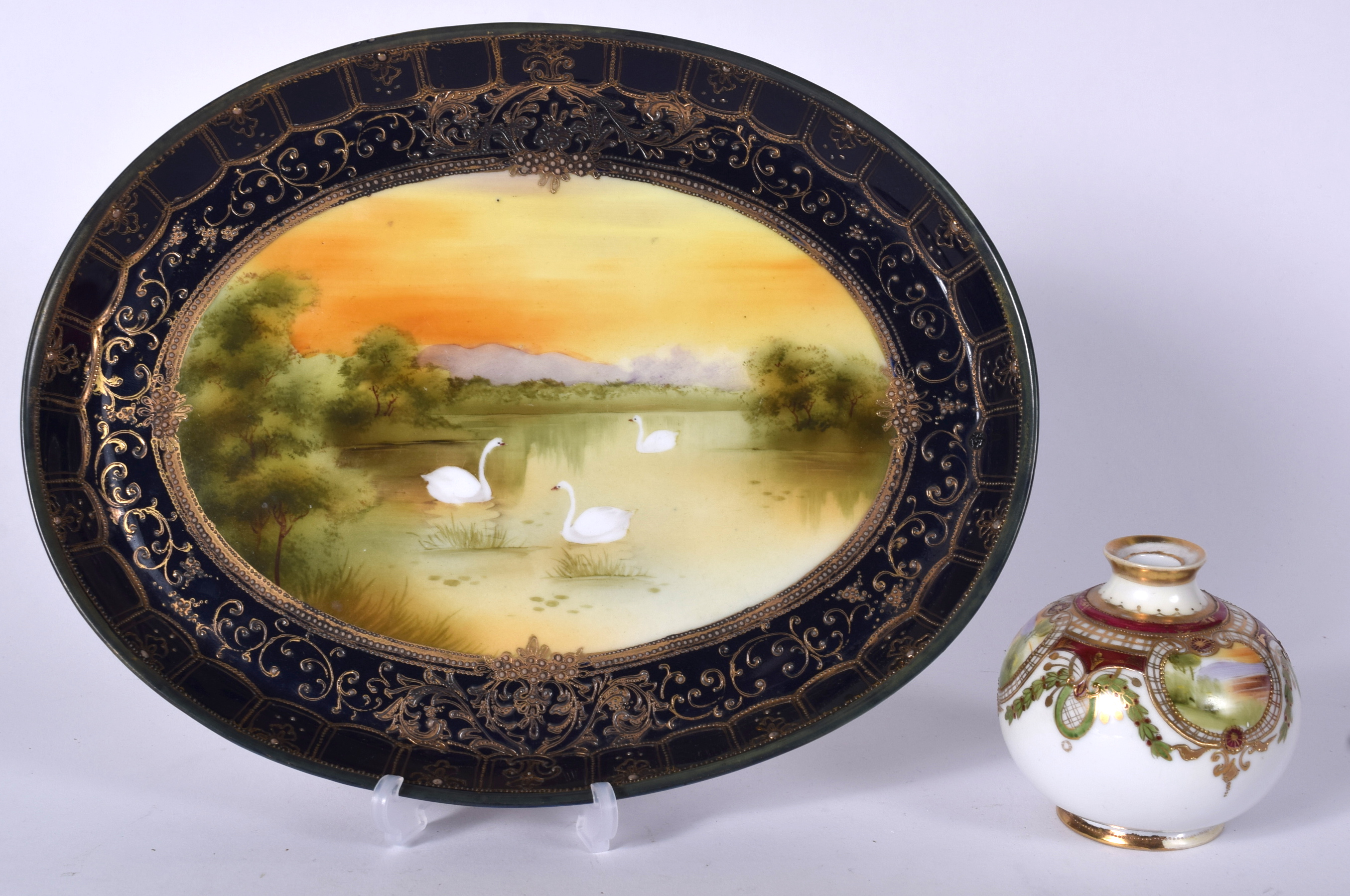 A JAPANESE NORITAKE PORCELAIN OVAL DISH DECORTAED WITH SWANS, together with a small vase. Tray 32 c