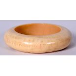 A LATE 19TH CENTURY CHINESE CARVED IVORY BANGLE, of thick flattened form. 9 cm wide.