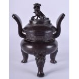 A 17TH CENTURY CHINESE TWIN HANDLED MING DYNASTY BRONZE CENSER AND COVER with lion dog finial. 16 c