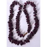 AN EARLY 20TH CENTURY CHINESE AMETHYST CARVED NECKLACE, formed with a yellow metal clasp. 60 cm lon