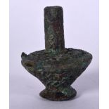AN EASTERN BRONZE VASE, decorated in relief with stylised vines and motifs. 11 cm high.