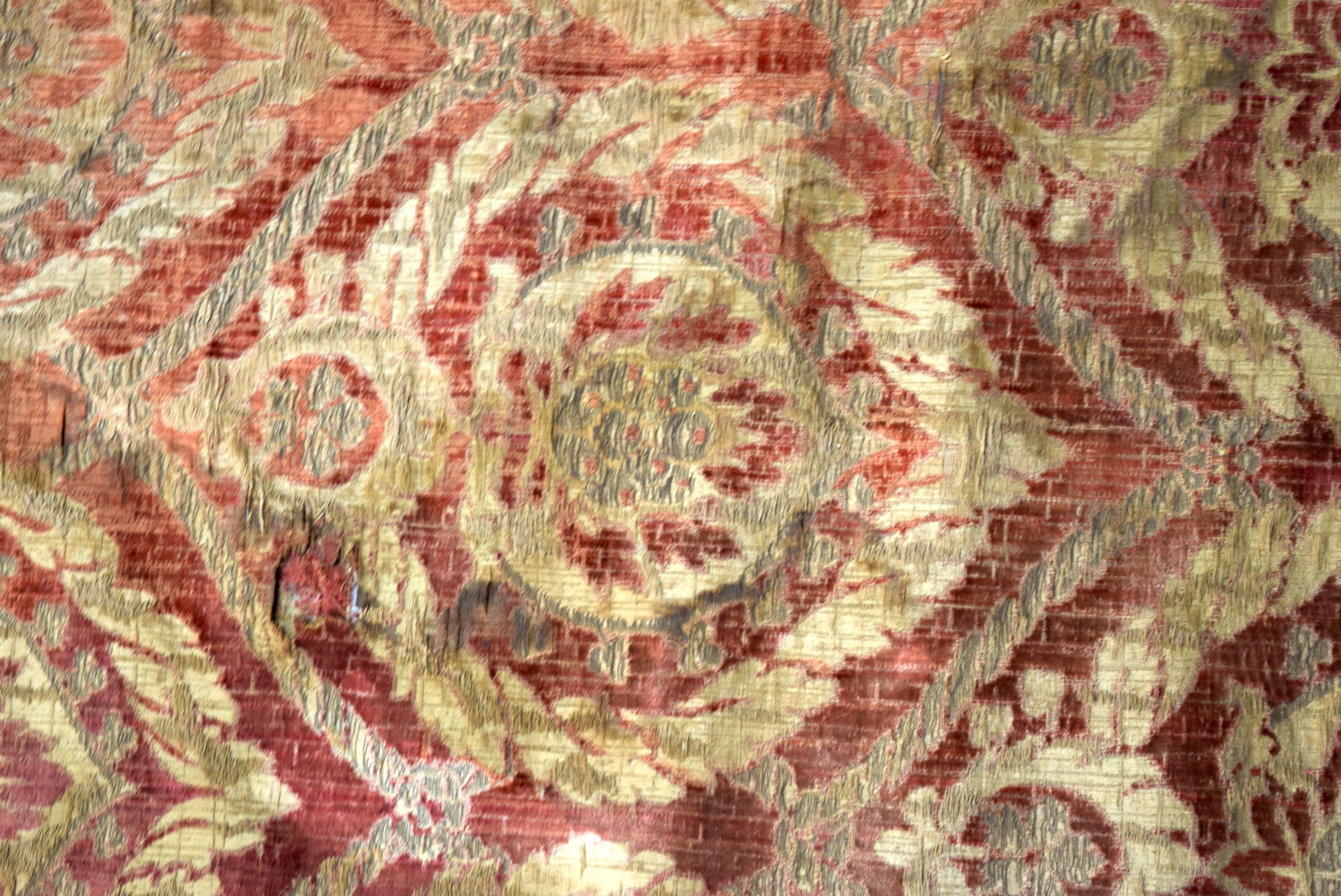 A RED GROUND OTTOMAN ISLAMIC TEXTILE, decorated with bold foliage. 84 cm x 55 cm. - Image 2 of 3