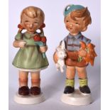 A PAIR OF HUMMEL STYLE PORCELAIN FIGURINES, in the form of a standing boy, together with a girl. 22