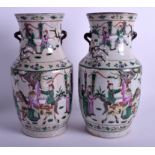 A PAIR OF 19TH CENTURY CHINESE FAMILLE VERTE CRACKLE GLAZED VASES painted with figures within lands