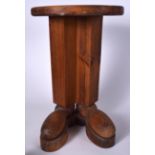 AN UNUSUAL VINTAGE PINE STOOL IN THE FORM OF STANDING LEGS WITH BOOTS, formed with a circular top.