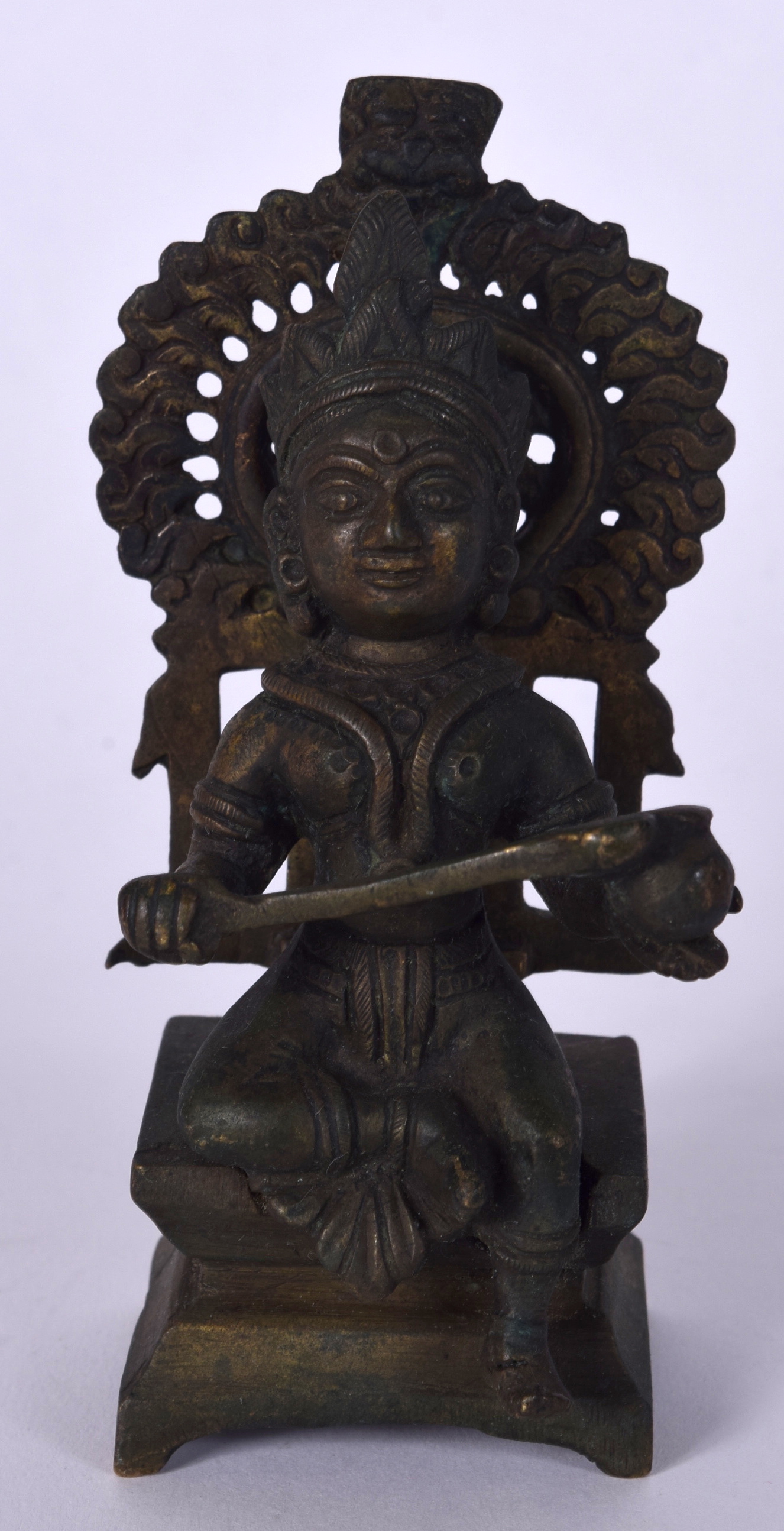 AN INDIAN BRONZE BUDDHA, together with removable shrine. 12 cm high.