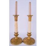 A PAIR OF 19TH CENTURY FRENCH ORMOLU EMPIRE CANDLESTICKS decorated with acanthus. 28 cm high.