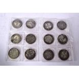 TWELVE CHINESE COINS, of varying decoration. 3.5 cm wide. (12)