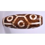 A LARGE TIBETAN CARVED HARDSTONE ZHU BEAD OR DZI BEAD, formed with geometric body. 11 cm long.