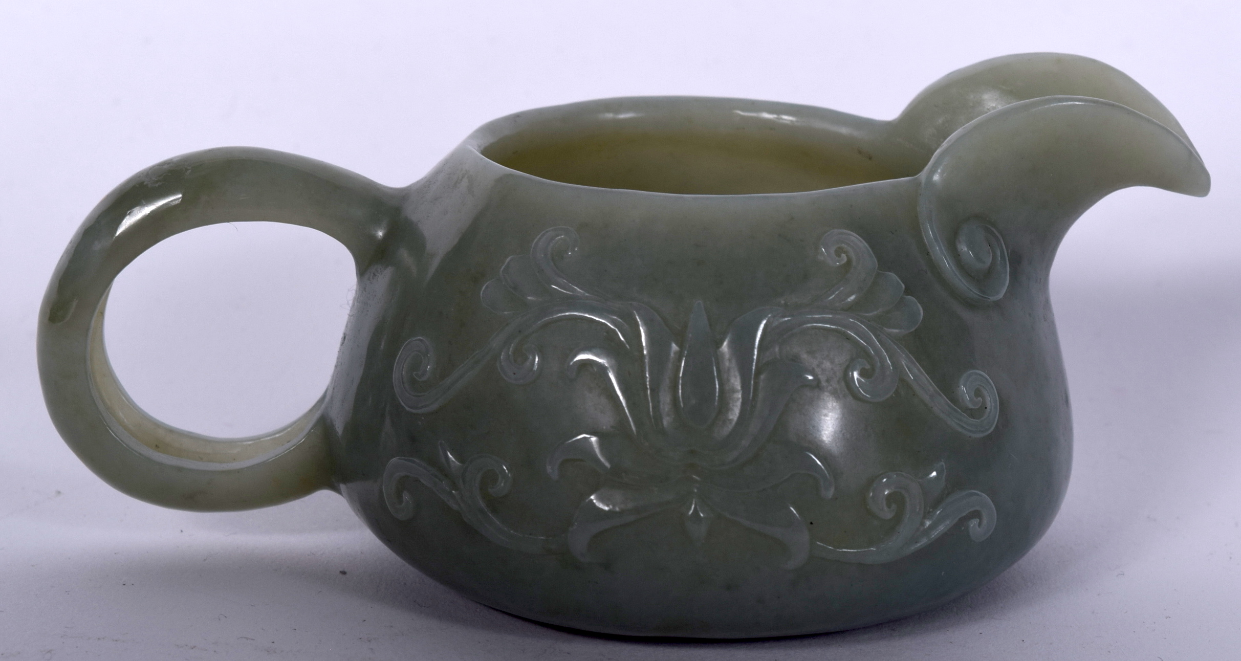 AN EARLY 20TH CENTURY CHINESE ISLAMIC MARKET GREEN JADE JUG, formed with a beak shaped spout and ca