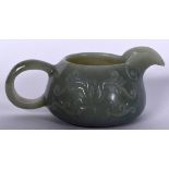 AN EARLY 20TH CENTURY CHINESE ISLAMIC MARKET GREEN JADE JUG, formed with a beak shaped spout and ca