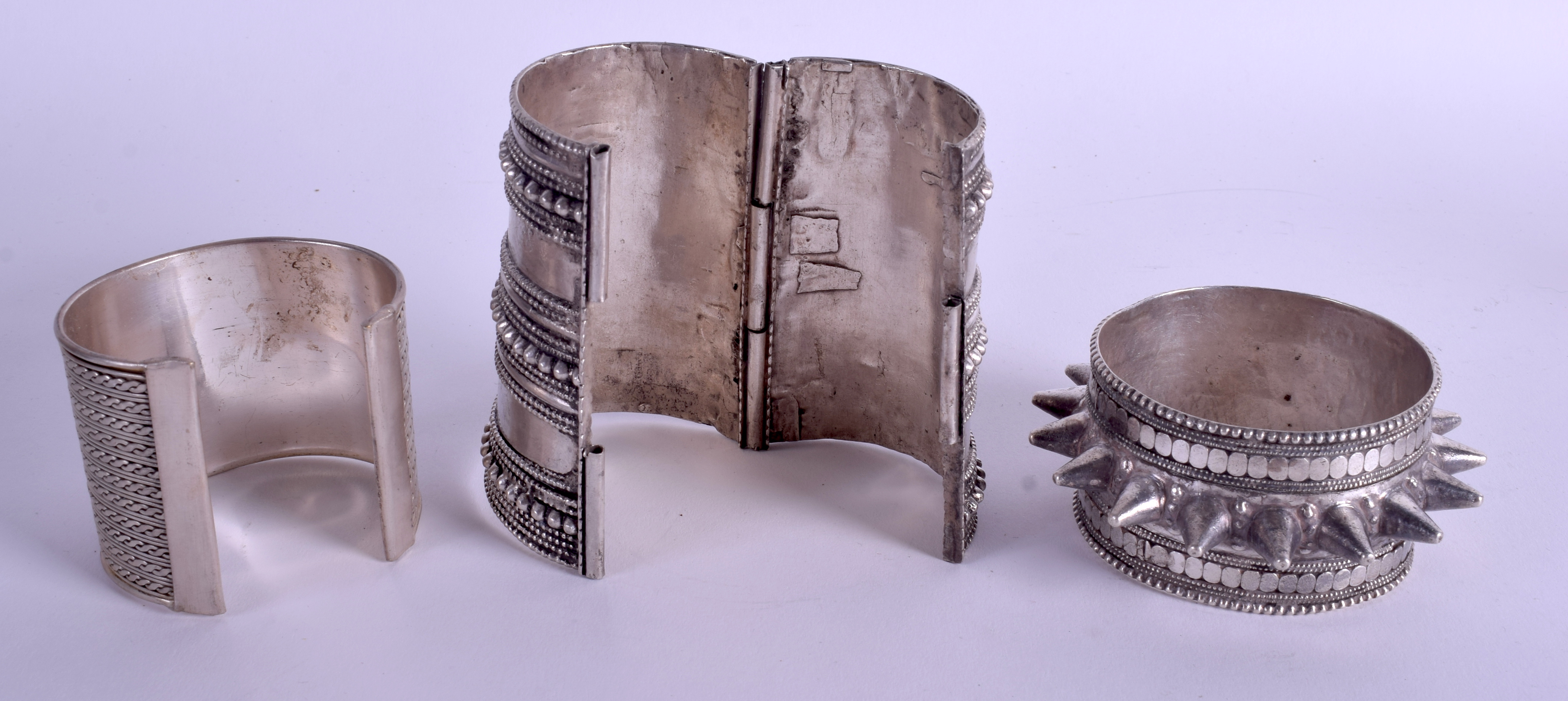 THREE MIDDLE EASTERN TRIBAL SILVER BRACELETS in various forms. 12.8 oz. Largest 9 cm long. (3) - Image 2 of 2