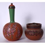 A TERRACOTTA STONEWARE WATER BOTTLE ENAMELLED WITH PINK FOLIAGE, together with a similar tobacco ja