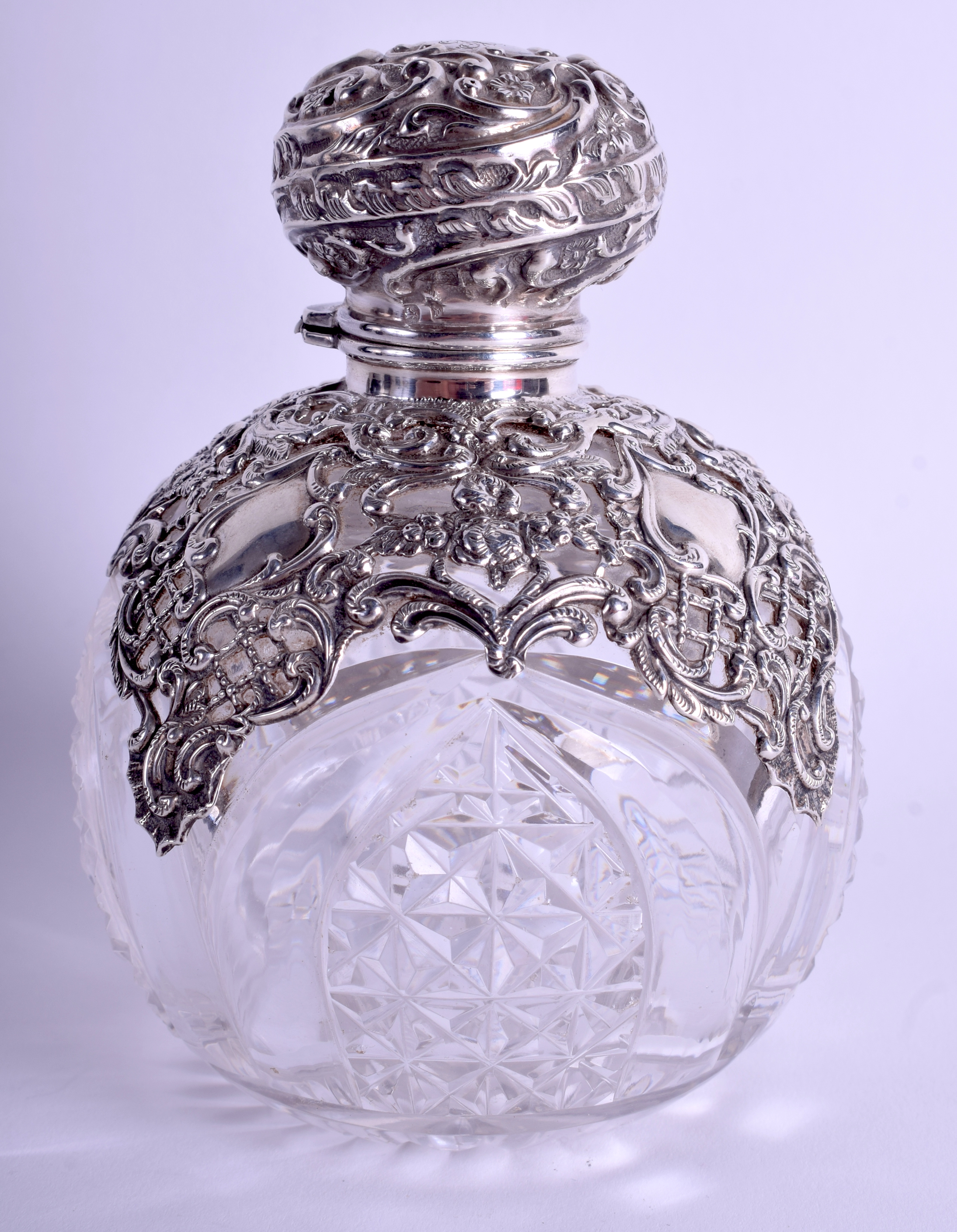 AN ANTIQUE SILVER OVERLAID CRYSTAL GLASS SCENT BOTTLE decorated with foliage and vines. 12 cm x 8 c