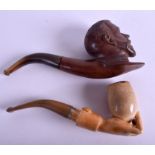 A RARE GEORGE CARVED WALNUT PIPE together with a meerschaum pipe carved as a hand. 15 cm long. (2)