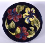 A MOORCROFT POTTERY DISH, painted with bold foliage. 30.5 cm wide.