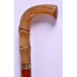 A 19TH CENTURY CARVED RHINOCEROS HORN HANDLED WALKING CANE. 77 cm long.