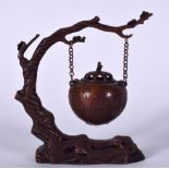 A 20TH CENTURY CHINESE BRONZE HANGING INCENSE BURNER, formed hanging from a withered tree. 19 cm x
