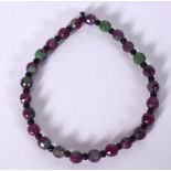A RUSSIAN CARVED PURPLE & GREEN FLUORITE TYPE HARDSTONE BRACELET, formed with facetted beads and bl