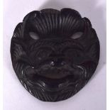 AN EARLY 20TH CENTURY CHINESE HARDWOOD BELT BUCKLE, in the form of a snarling demon. 5.2 cm x 4.8 c