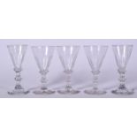 A SET OF FIVE ANTIQUE GEORGIAN GLASSES, formed with double knop stems. 12 cm high. (5)