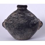 A PERSIAN ISLAMIC POTTERY VASE, decorated in relief with a swimming fish. 11 cm x 13.5 cm.
