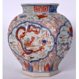 A CHINESE MING STYLE WUCAI PORCELAIN VASE, painted with a dragon amongst the clouds. 20 cm high.