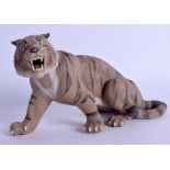 A 1950S CHINESE YIXING POTTERY FIGURE OF A TIGER modelled scowling. 22 cm x 12 cm.