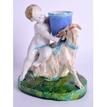 A 19TH CENTURY MAJOLICA FIGURE OF A PUTTI possibly Minton, modelled riding a goat. 16 cm x 11 cm.